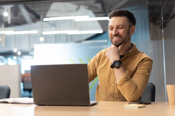 istock Cheerful Businessman Using Laptop Working Online In Office 1467628291
