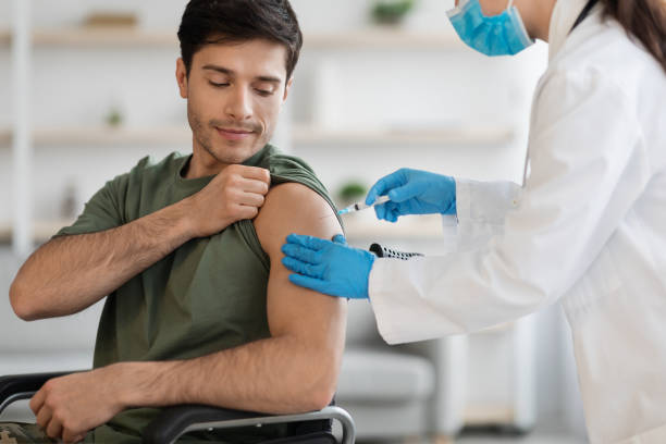 istock Closeup of disabled soldier getting immunization against coronavirus at clinic 1467628384