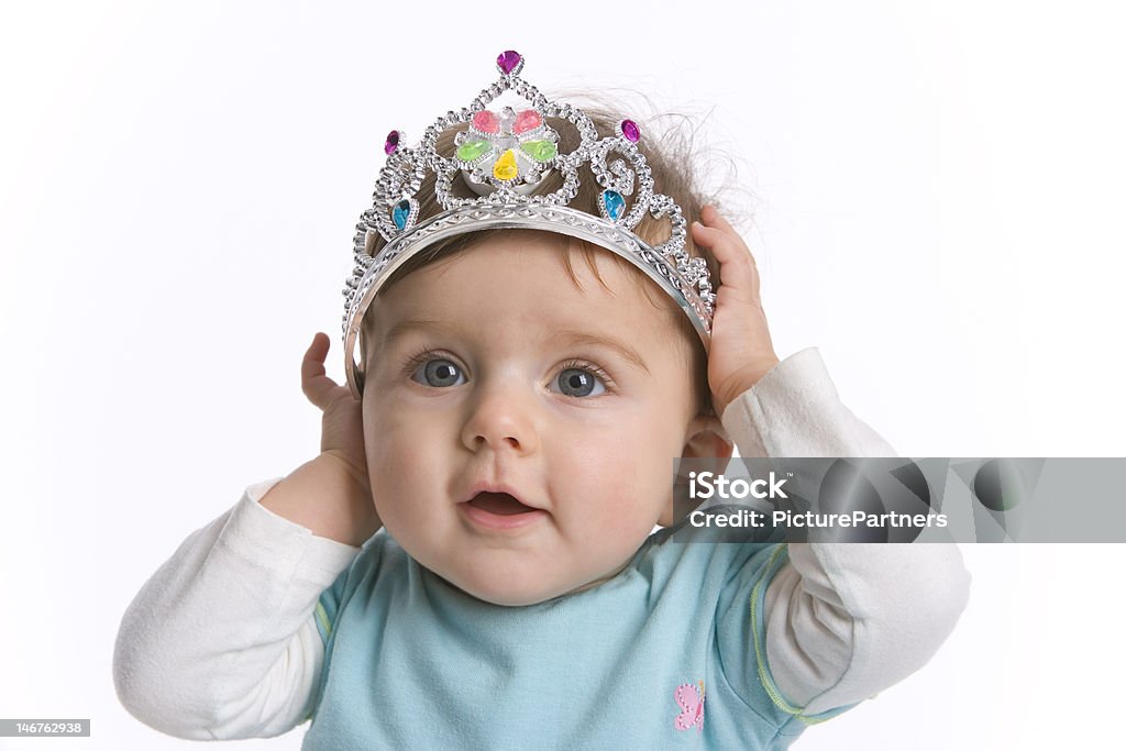 Toddler girl with a toy crown Toddler girl with a toy crown on white background 12-17 Months Stock Photo