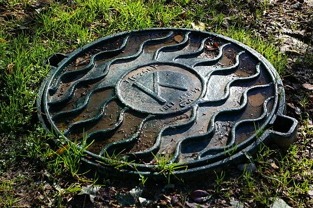 Sewer manhole cover stock photo