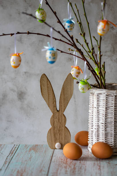 istock Branches with Easter eggs in a vase of willow branches and Easter bunny on a light background 1467631037