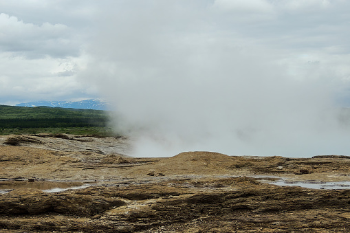 Famous Iceland Geysir in Geothermal Area of Haukadalur Valley is an image showcasing the iconic geysir in the Haukadalur Valley of Iceland.