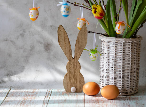 istock Branches with Easter eggs in a vase of willow branches and Easter bunny on a light background 1467631147