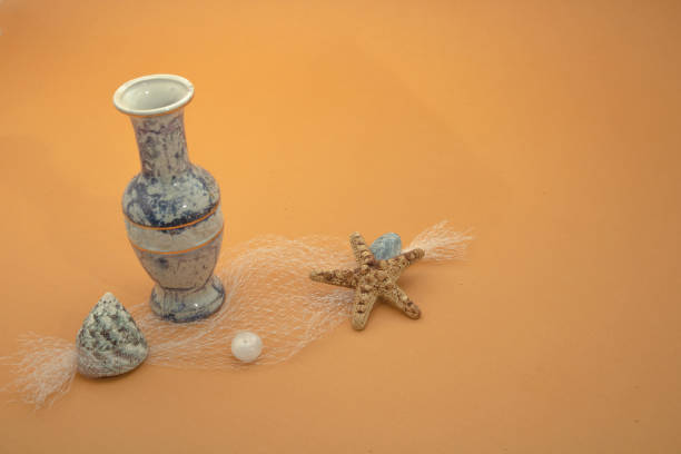 on a sunny sandy beach shells starfish with pearl jar with treasure sea net