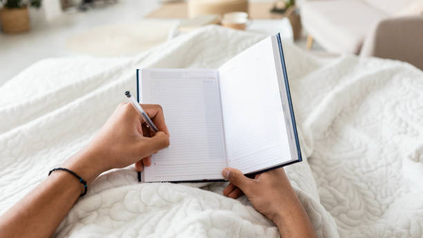 istock Male Holding Planner In Hands Taking Notes In Bedroom, POV 1467632109