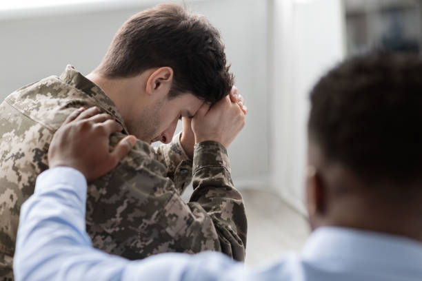 istock Unrecognizable black man comforting upset soldier, back view 1467632172