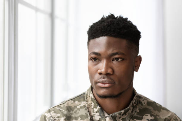 istock Serious african american man soldier looking through the window 1467632182