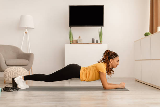 istock Sporty Woman Exercising Doing Plank Training At Home 1467632237