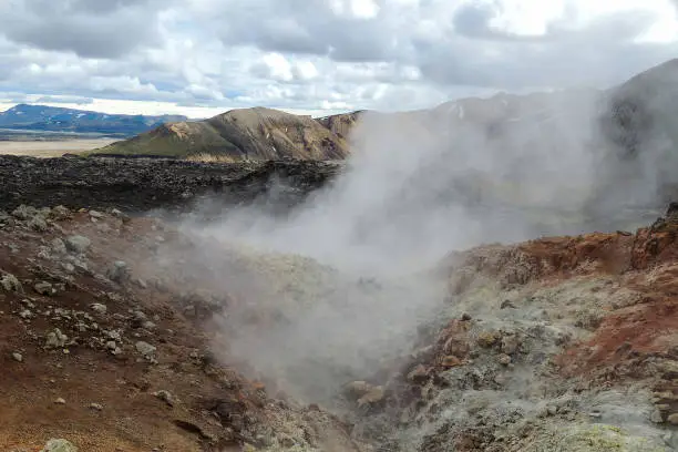 Photo of Hot Steam Geysers In Mountain Terrain