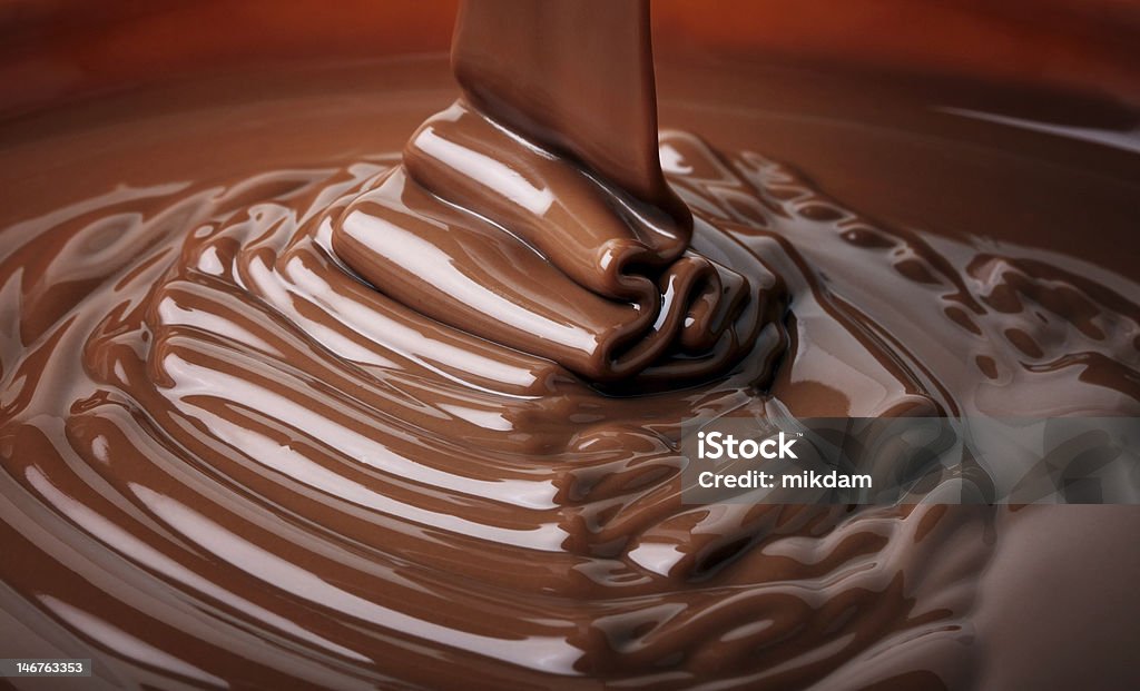 Molten chocolate flowing into a bowl 
chocolate flow Chocolate Stock Photo