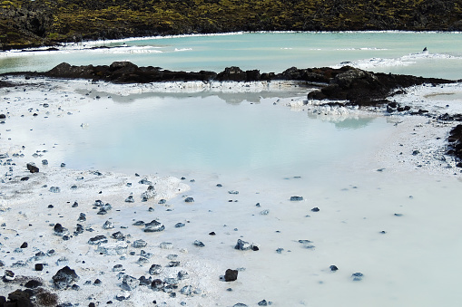 Clear Sky Blue Water Iceland: A breathtaking image of a serene blue body of water surrounded by a clear sky and rugged landscapes, perfect for use in tourism, nature, and environmental projects.