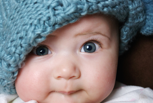 cute baby wearing a  blue Winter hat