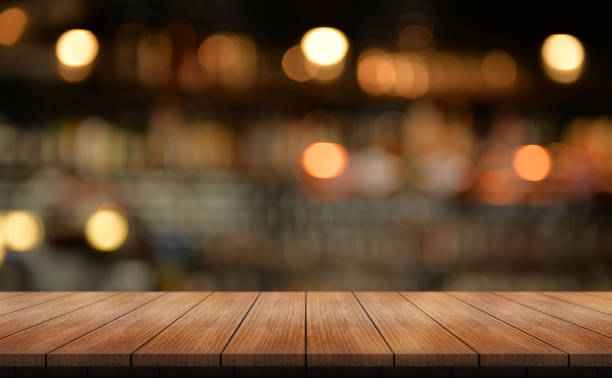 istock Empty wooden table top with lights bokeh on blur restaurant background. 1467641805
