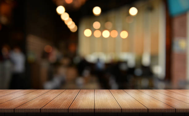 istock Empty wooden table top with lights bokeh on blur restaurant background. 1467641809