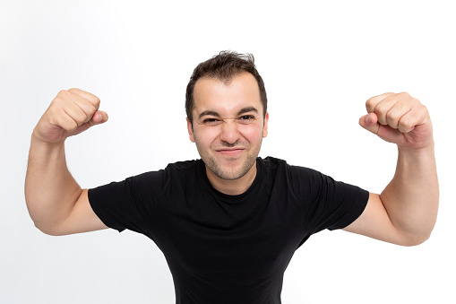 Happy expressive man shouts celebrating victory success and triumph on white background.