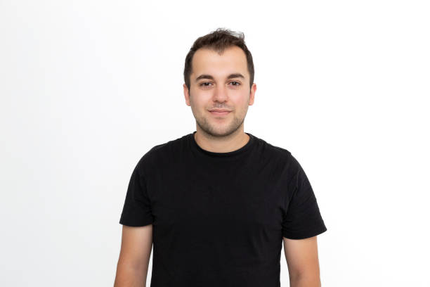 istock Young man wearing black t-shirt against white background. 1467642072