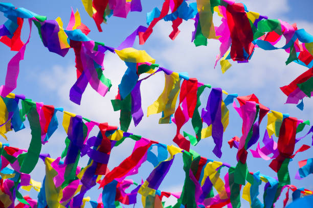 istock Colorful Mexican party streamers hanging outdoors against a blue sky 1467642480