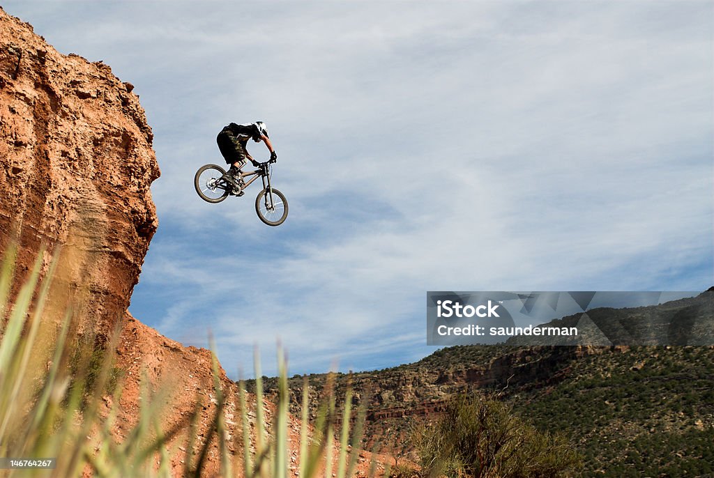 cactus jump A mountain biker takes to the sky. Desert Area Stock Photo