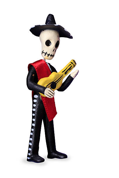 Cute skull-man representing the Day of the Dead Mariachi Day of the Dead skeleton mariachi figure from Mexico on white mariachi dolls stock pictures, royalty-free photos & images