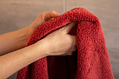 Woman drying her hands with a towel in the bathroom