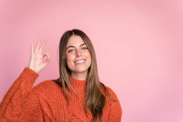 istock Smiling woman showing OK gesture 1467650654