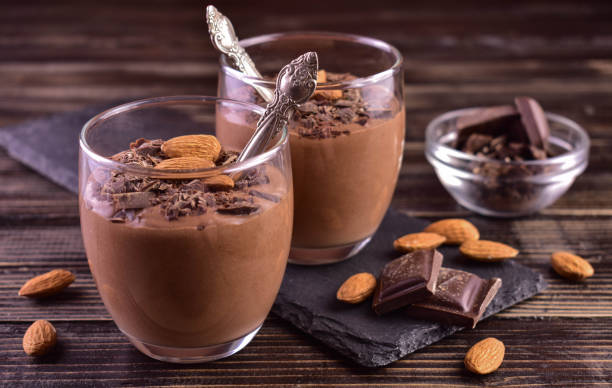 istock Chocolate mousse with almonds in glasses on a dark wooden background. 1467650822