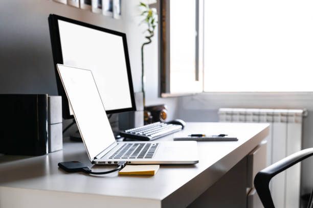 istock Workspace at home with computer, laptop, hard drive, white desk and open window with natural light. Working from home and distance work concept. concept. Distance working concept. 1467650991