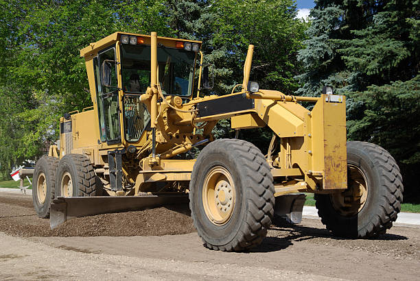 istock Yellow tractor over a dirt road next to green trees 146765369