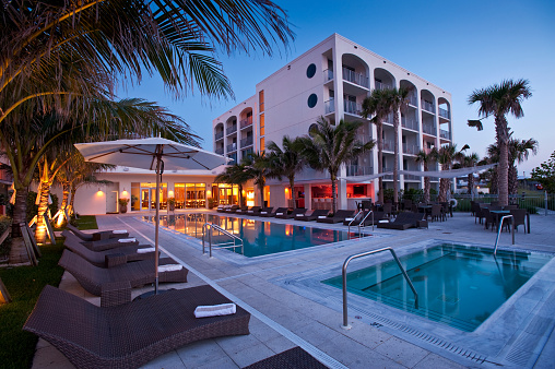 Beautiful Florida Beach Hotel at sunrise with swimming pool reflection