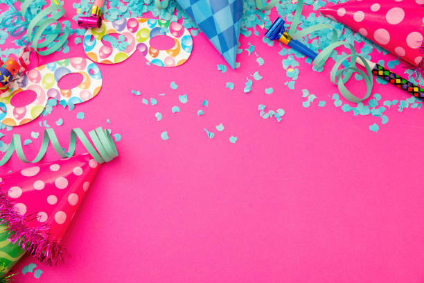 Carnival party supply. Confetti, serpentine, mask, shiny hat on pink background. Invitation card, ad template, copy space. Overhead view.