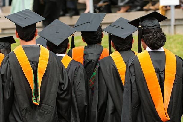 Students walking toward commencement stock photo