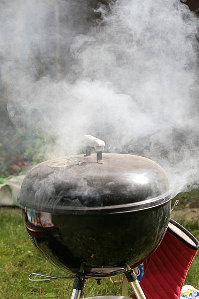 Smoking grill outdoors stock photo