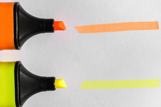 istock the orange and yellow highlighters on a white paper 1467662946