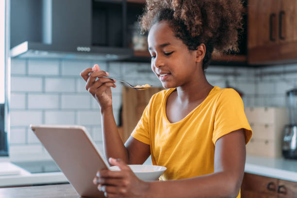 istock Happy girl having breakfast at home. 1467663683