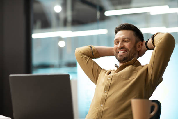 istock Happy Businessman Looking At Laptop Computer Relaxing Sitting In Office 1467665139