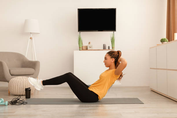 istock Fit Black Lady Exercising Doing Abs Crunches Flexing Abdomen Indoors 1467665253