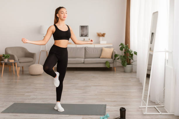 istock Lady Standing In Yoga Pose On One Leg Meditating Indoors 1467665257