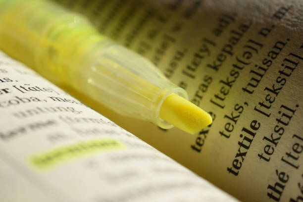 Close Up of Page Markers in yeloow Note Pad on table