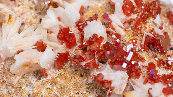 Lustrous blood-red vanadinite crystals on the snow-white bladed baryte matrix.
