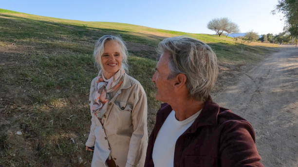 istock Mature couple walk along rural path, at sunrise 1467669985
