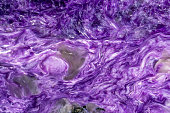 Lavender charoite mineral texture with swirling white streaks and pearly luster. Natural stone from Russia
