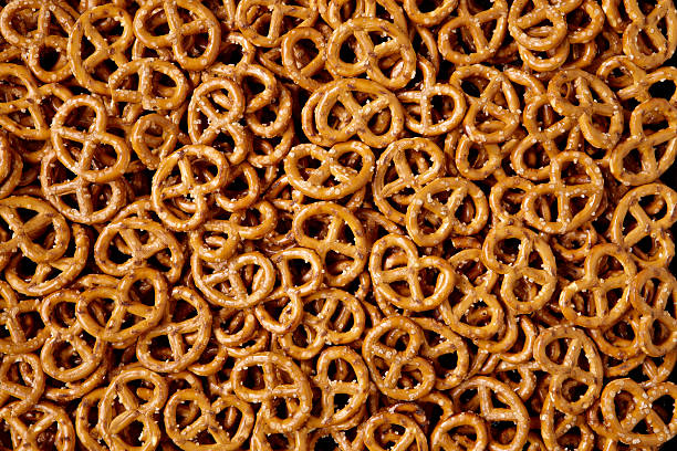 Bin filled with small, salty pretzels An abundance of pretzels full frame. pretzel photos stock pictures, royalty-free photos & images