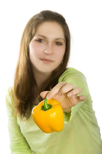 istock Girl with yellow pepper on a white background 146767424