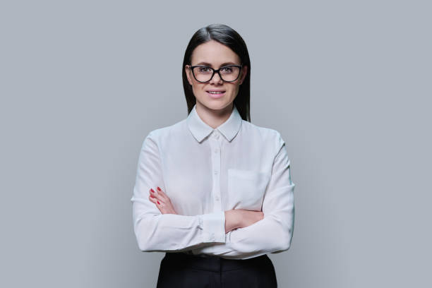 istock Young woman in glasses looking at camera on blue background 1467674389