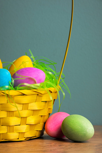 A close up of Easter eggs flowing from a basket.