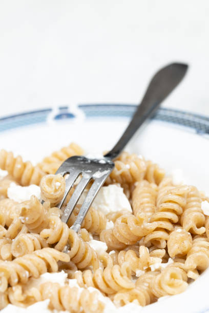 Macaroni pasta with cheese served in the plate with closesup macro shots.