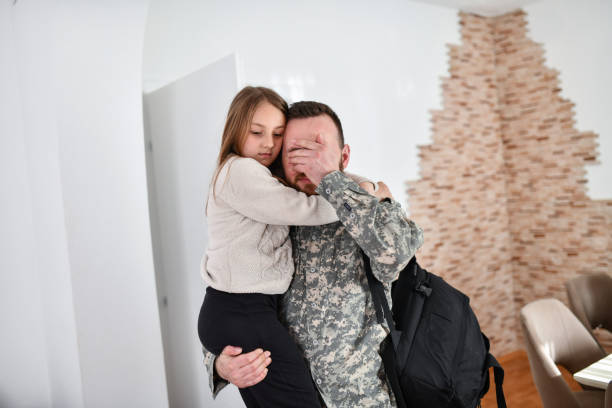 istock Male Soldier Crying While Embracing Daughter Before Leaving For The Front 1467683332