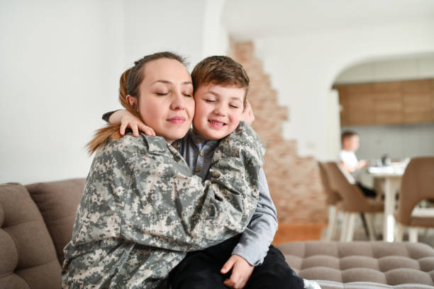 istock Loving Boy Embracing Mother In Military Uniform 1467683636