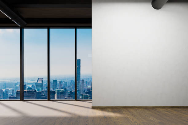 istock large office with blank white wall and copy space in front of panoramic window skyline view, wooden parquet floor; 3D Illustration 1467684882