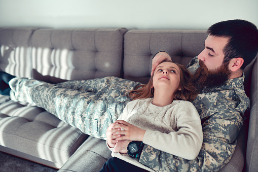 Bearded Father Embracing Daughter And Spending Time With Her After Work In Military